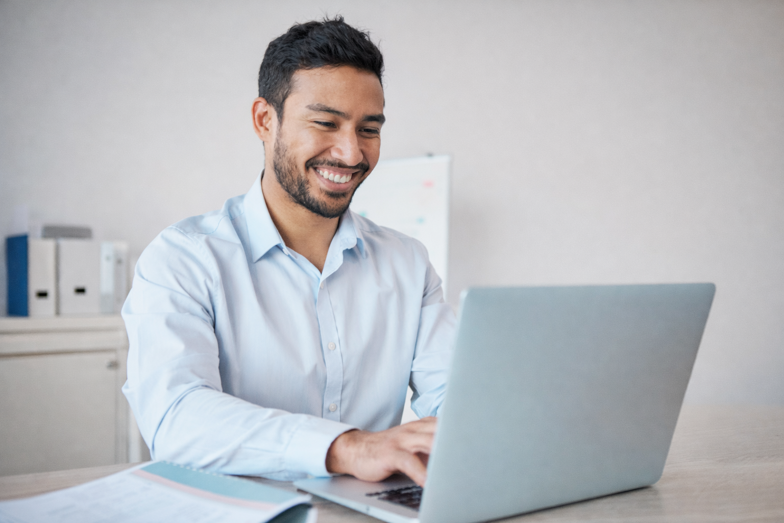 Business professional working confidently on a laptop after IT issues are resolved with Waterdog Technology Solutions support.